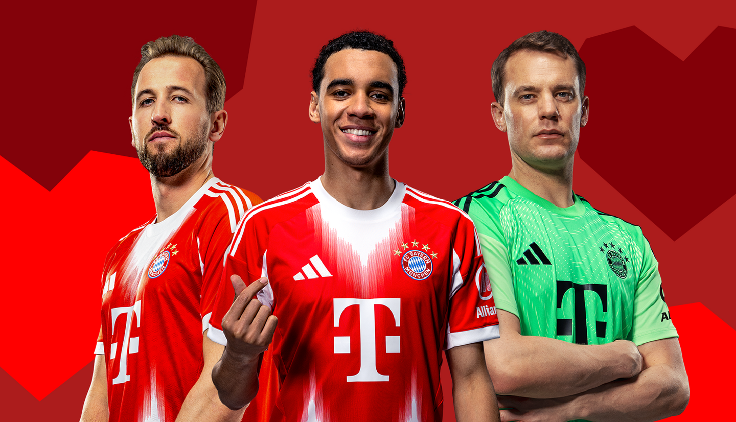 Three football players pose confidently in team jerseys. The player in the center smiles and gestures playfully, while the others stand seriously on either side. The background features a deep red color, enhancing the team's colors and logo displayed prominently on their shirts.